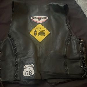 Woman leather motor cycle vest fist like a large. Has pockets.